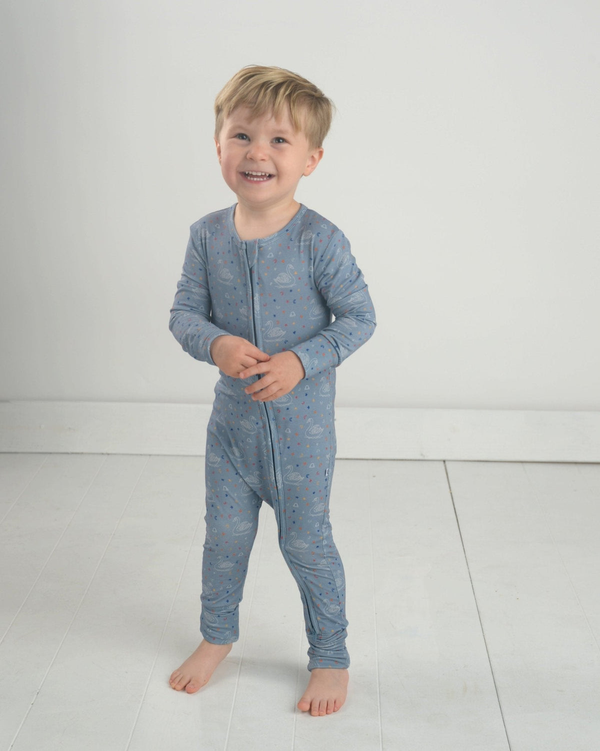 Blue zodiac-themed toddler bamboo romper with full zip front and long sleeves.