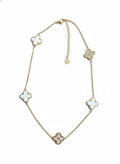 Gold-tone charm necklace with four clover motifs and small round accents