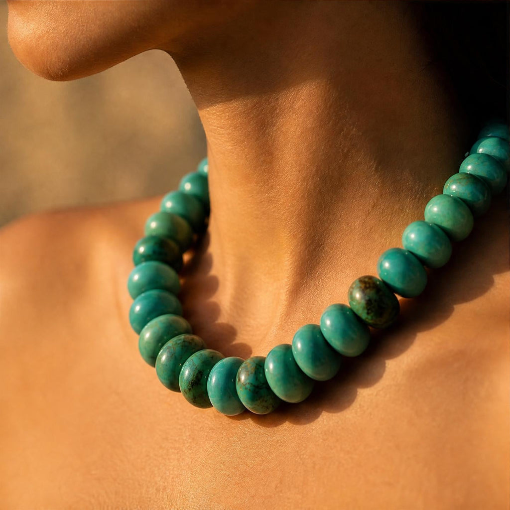 Turquoise beaded necklace with rounded beads and a snug collar fit.
