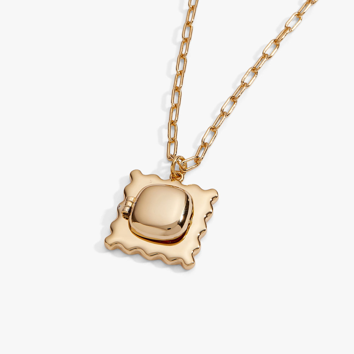 Gold scalloped locket pendant necklace with reflective center shown on a chain