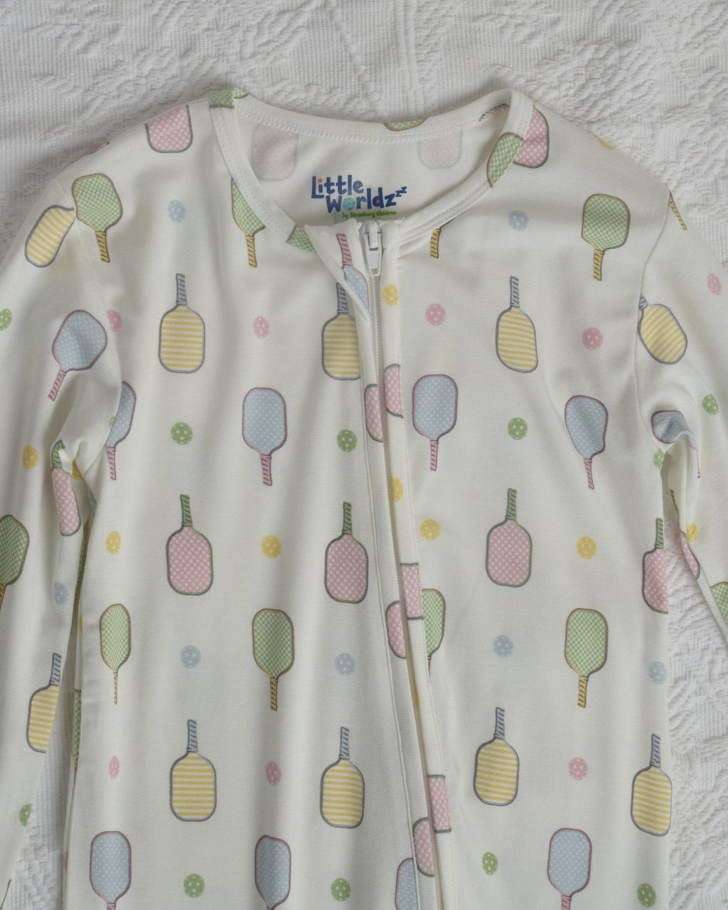 Close-up of toddler pajama romper neckline and chest, white with popsicle pattern