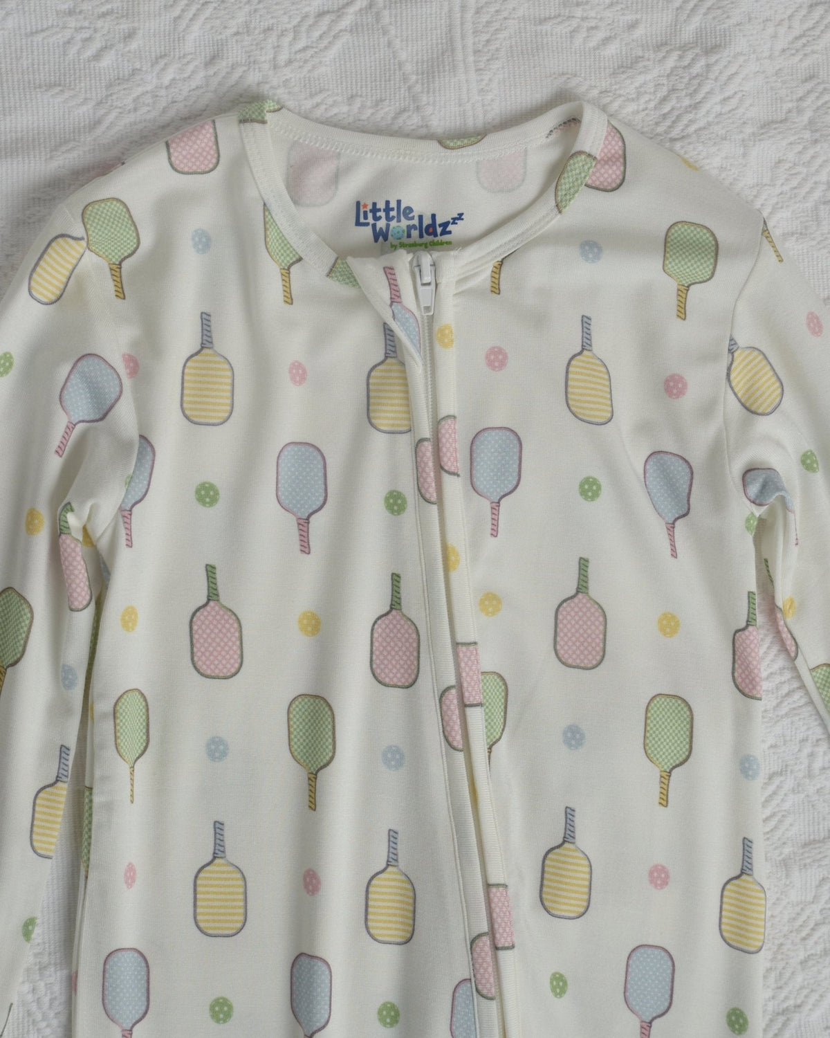 Close-up of toddler pajama romper neckline and chest, white with popsicle pattern
