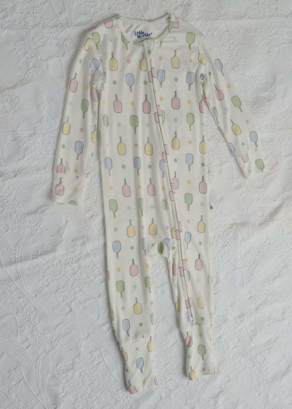 Flat lay of toddler long-sleeve footed pajama romper, white with popsicle pattern