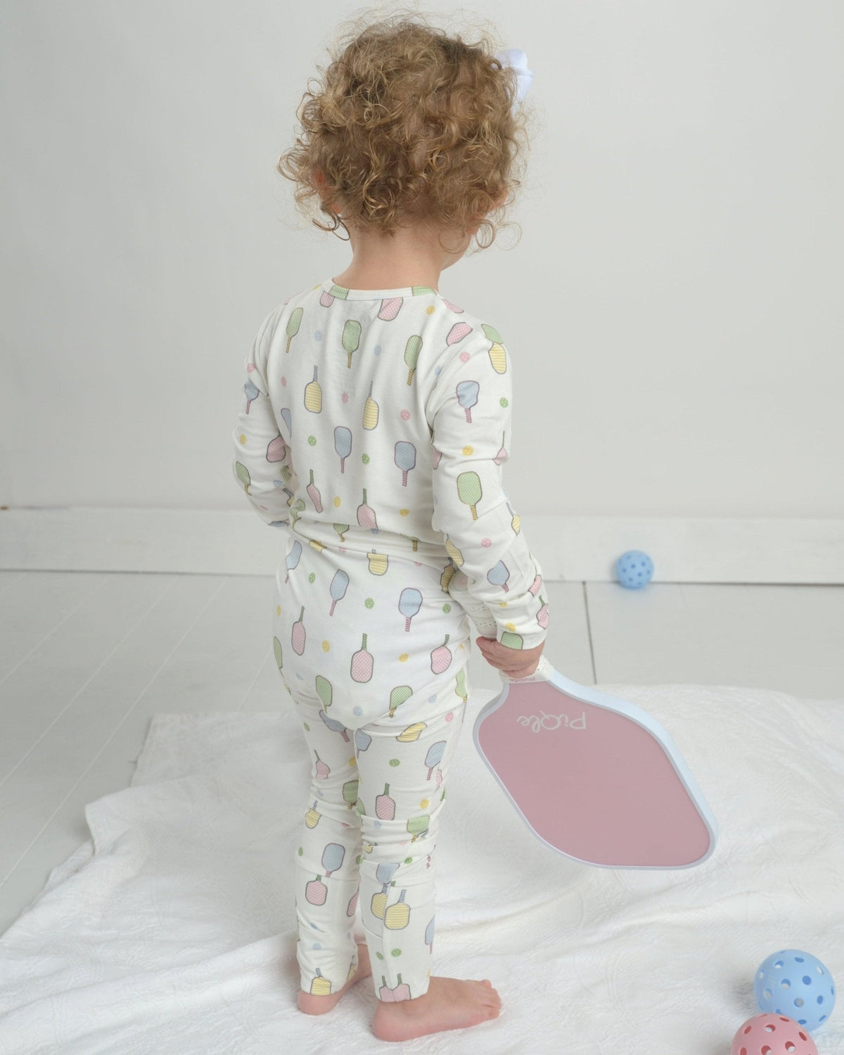Toddler pajama romper back view in white with colorful popsicle graphic print