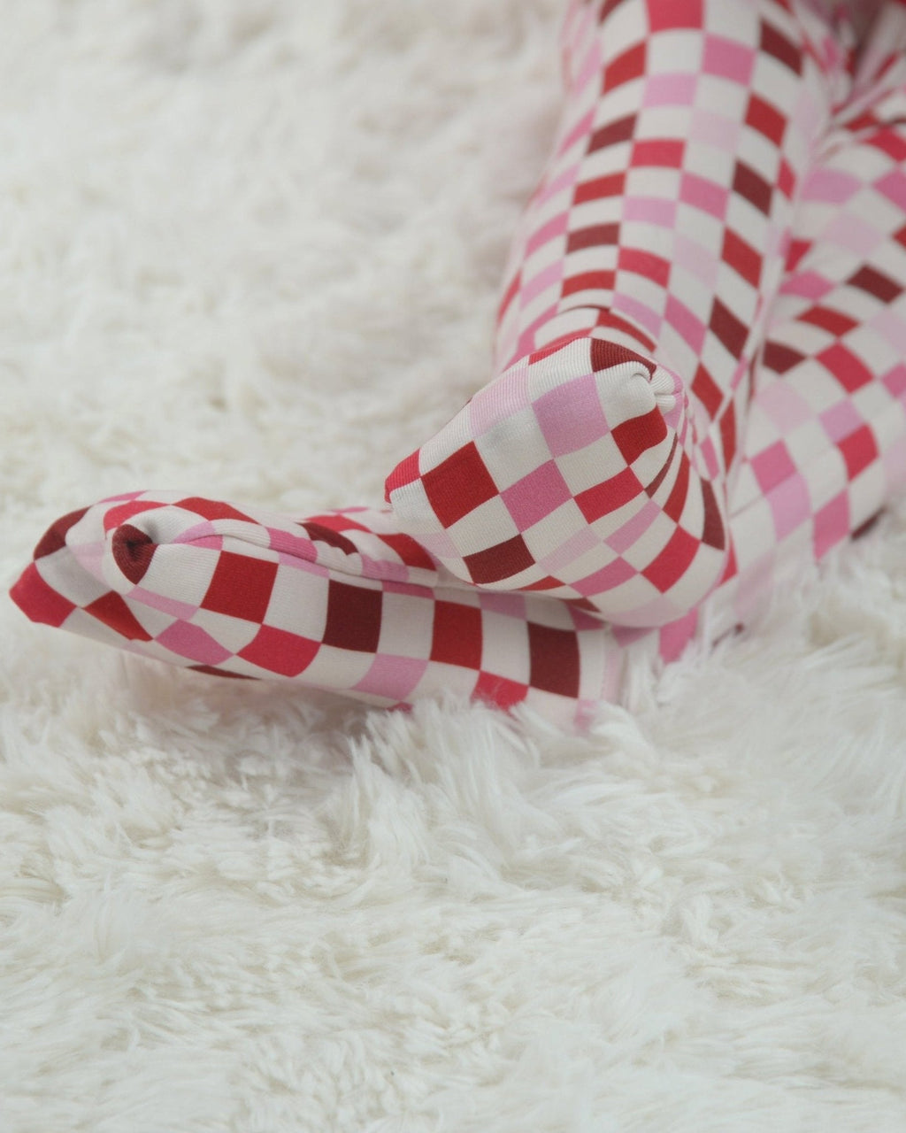 Pink and red checkered long sleeve cuff detail on toddler pajama romper