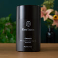 Emerald green tea tin, Rare Leaves label on dark cylindrical container