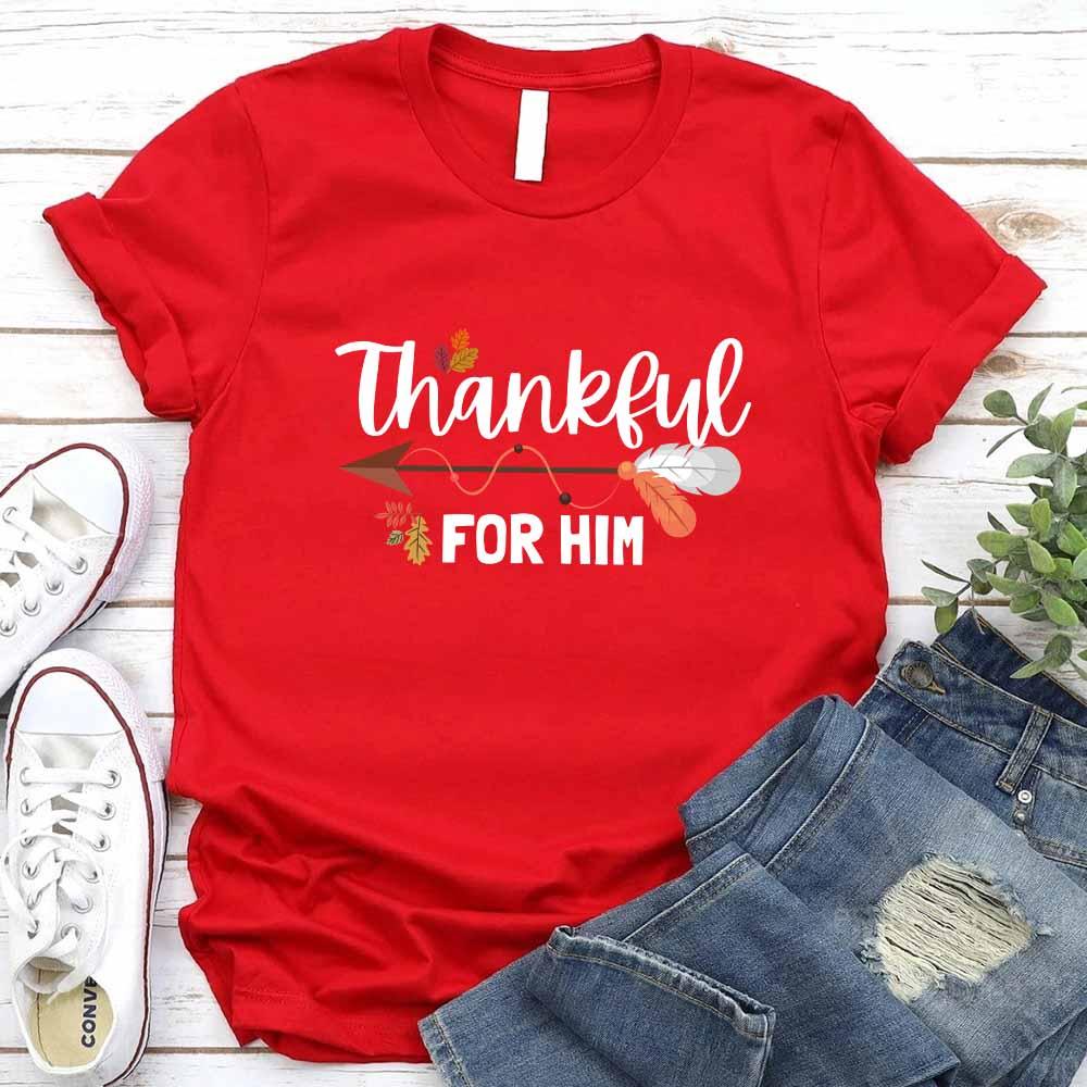 Red T-shirt with “Thankful” and “FOR HIM” holiday graphic print.