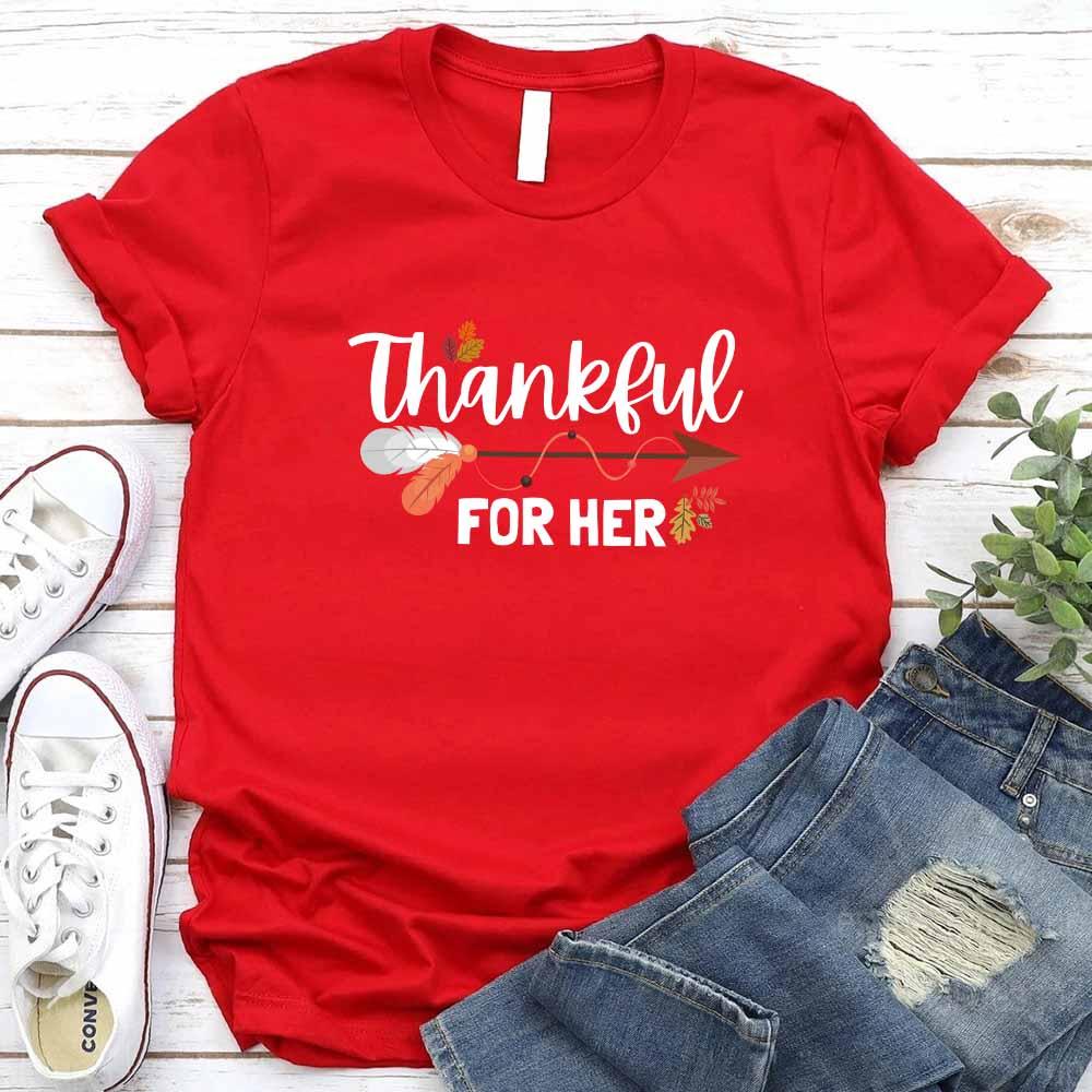 Red T-shirt with “Thankful” and “FOR HER” holiday graphic print.