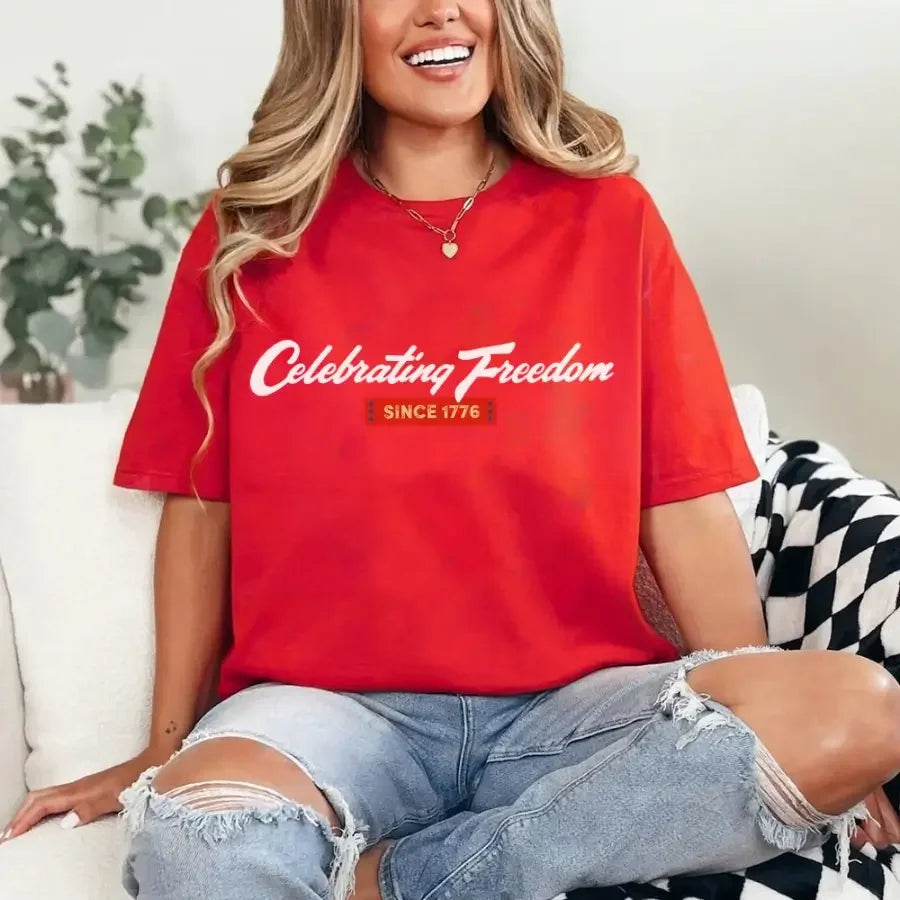 Red women's graphic T-shirt with 'Celebrating Freedom' and 'Since 1776' print
