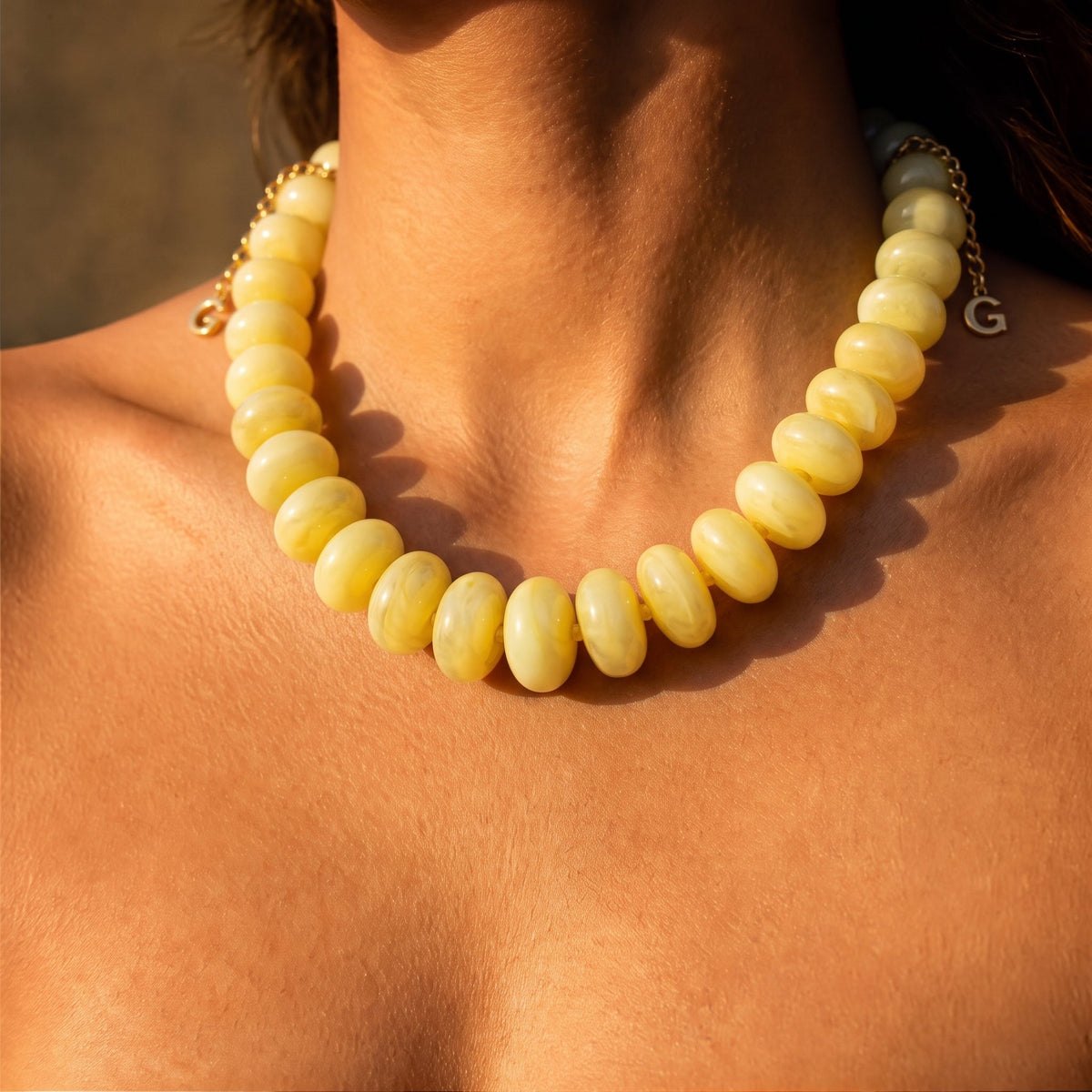 Butter yellow beaded necklace with rounded beads and a snug collar fit.
