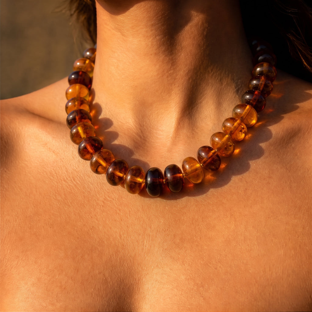 Amber beaded necklace with rounded beads and a snug collar fit.