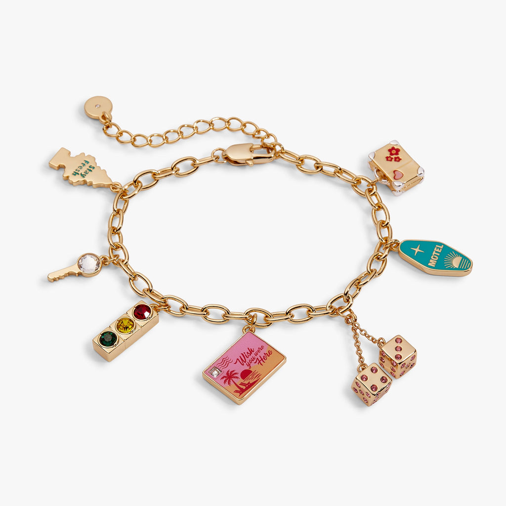 Gold-toned chain bracelet with multiple travel-themed charm dangles