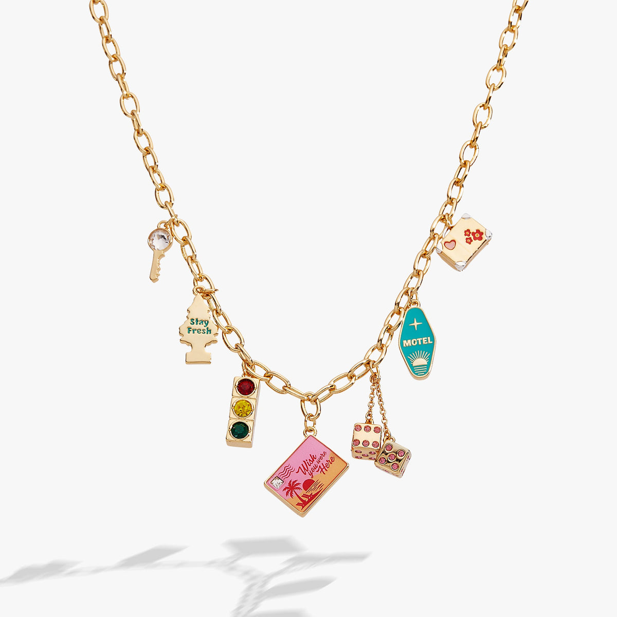 Gold multi-charm necklace with colorful travel-themed pendants on link chain