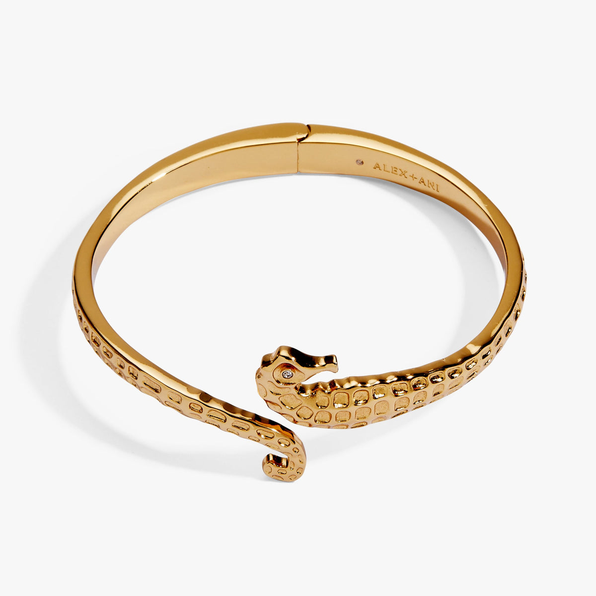 Gold-toned seahorse bypass cuff bracelet showing open design and textured seahorse head