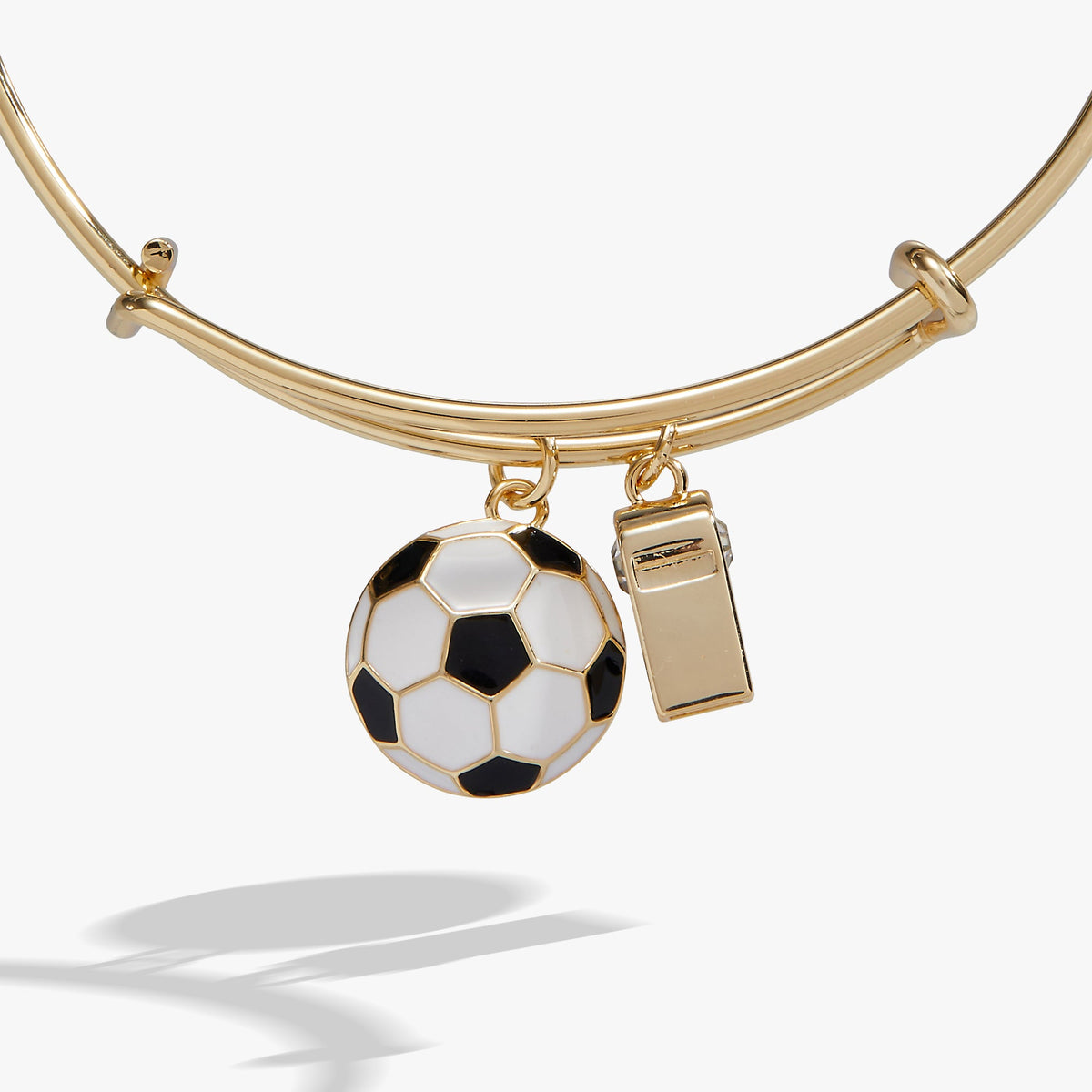 Gold bangle bracelet with soccer-ball charm and whistle charm