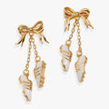 Gold-tone soccer cleat dangle earrings with bow tops and chain drops