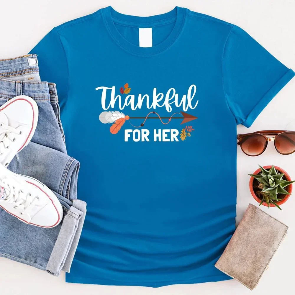 Blue T-shirt with “Thankful” and “FOR HER” holiday graphic print.