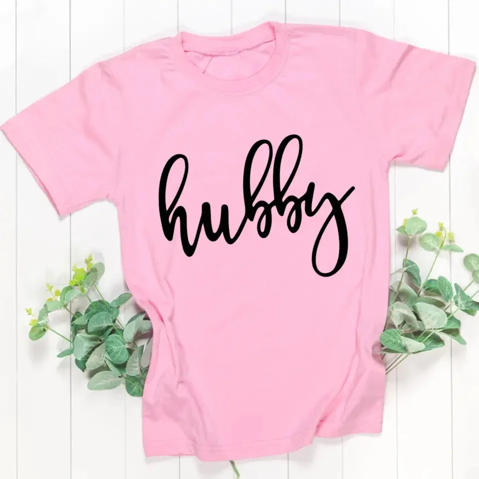 Light pink unisex couple tee with “hubby” script print centered on the chest