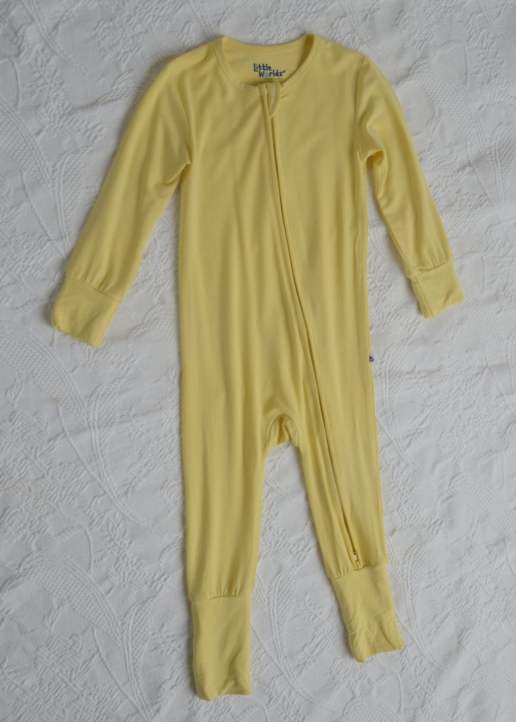 Yellow long-sleeve toddler romper pajamas with zip front and footed pant legs