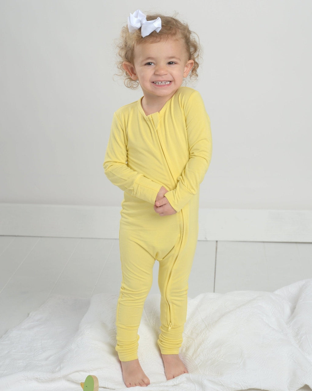 Yellow toddler bamboo romper pajamas with long sleeves and cuffed legs