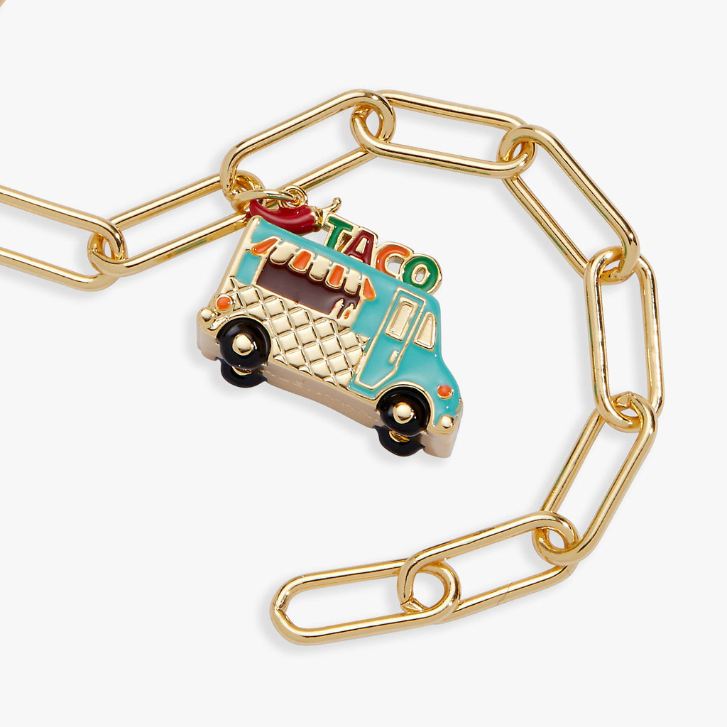 Gold toggle bracelet featuring a colorful taco truck charm on linked chain