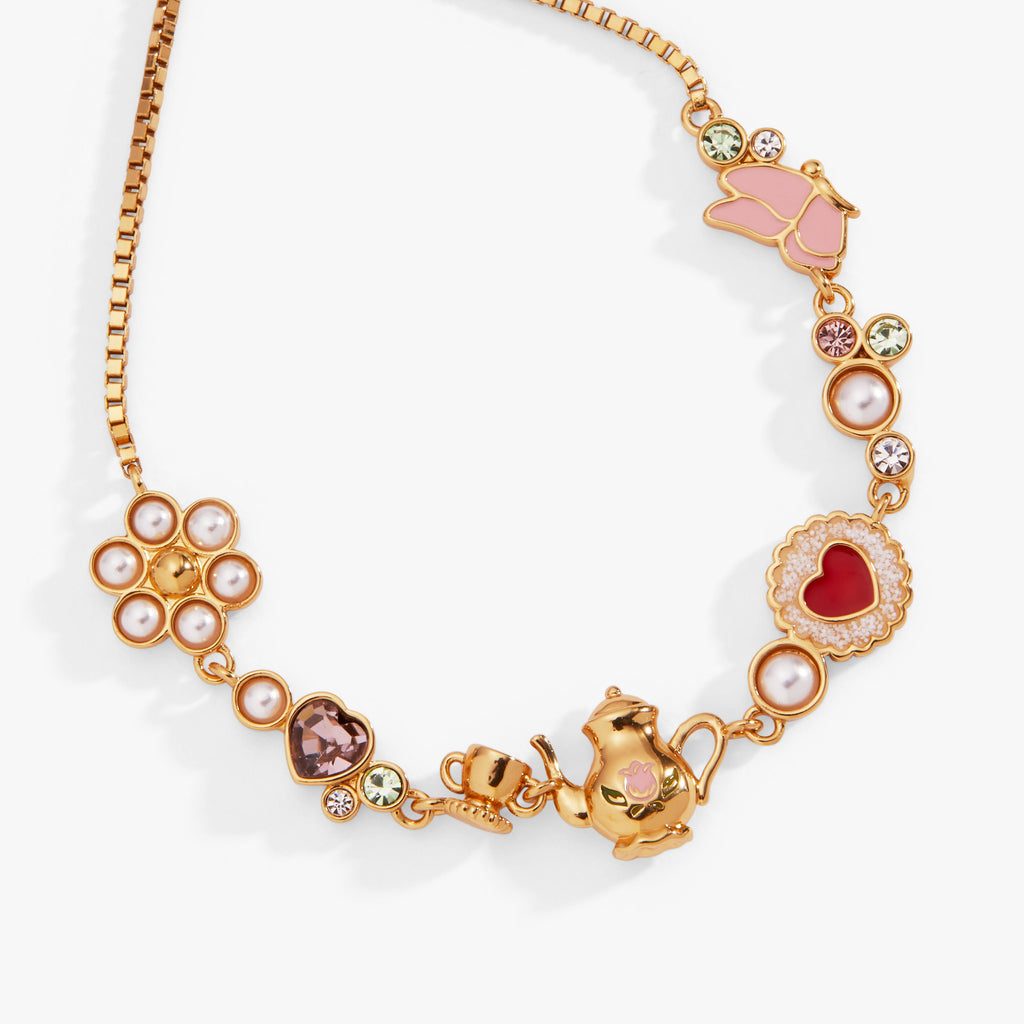 Gold-tone bolo bracelet with heart, flower, pearl, and teapot charms
