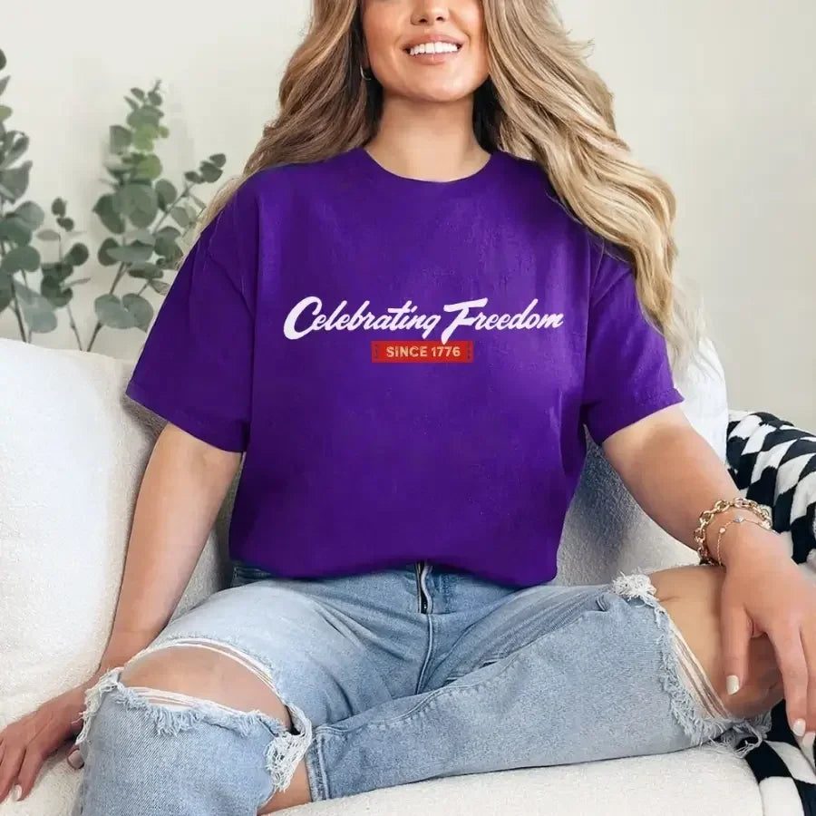 Purple women's graphic T-shirt with 'Celebrating Freedom' and 'Since 1776' print