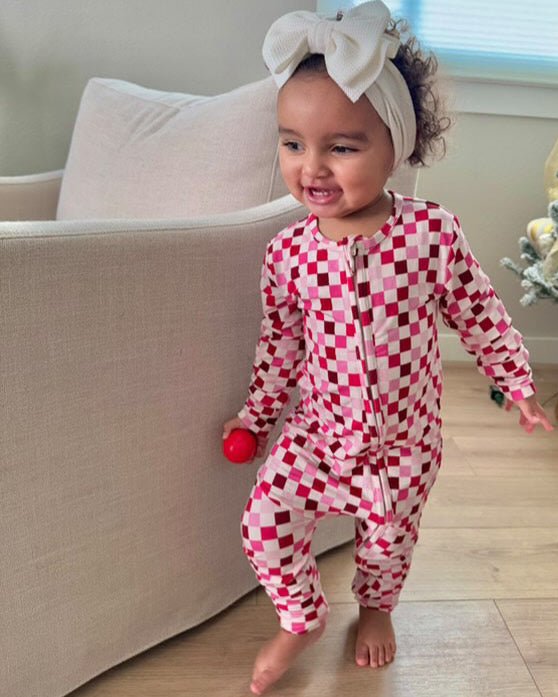 Pink and red checkered toddler pajama romper, long sleeves and full-length legs