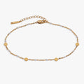 Gold chain anklet with round coin charms and white enamel station links