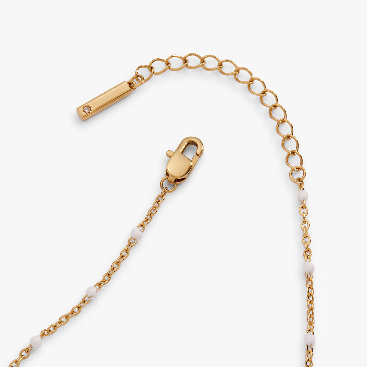 Gold anklet with bar tag and padlock charm, coin discs and white enamel links