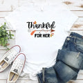 White T-shirt with “Thankful” and “FOR HER” holiday graphic print.
