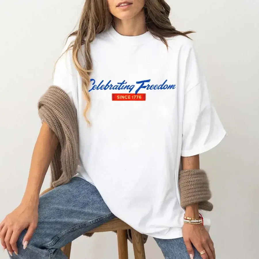 White graphic t-shirt with “Celebrating Freedom” and “Since 1776” print